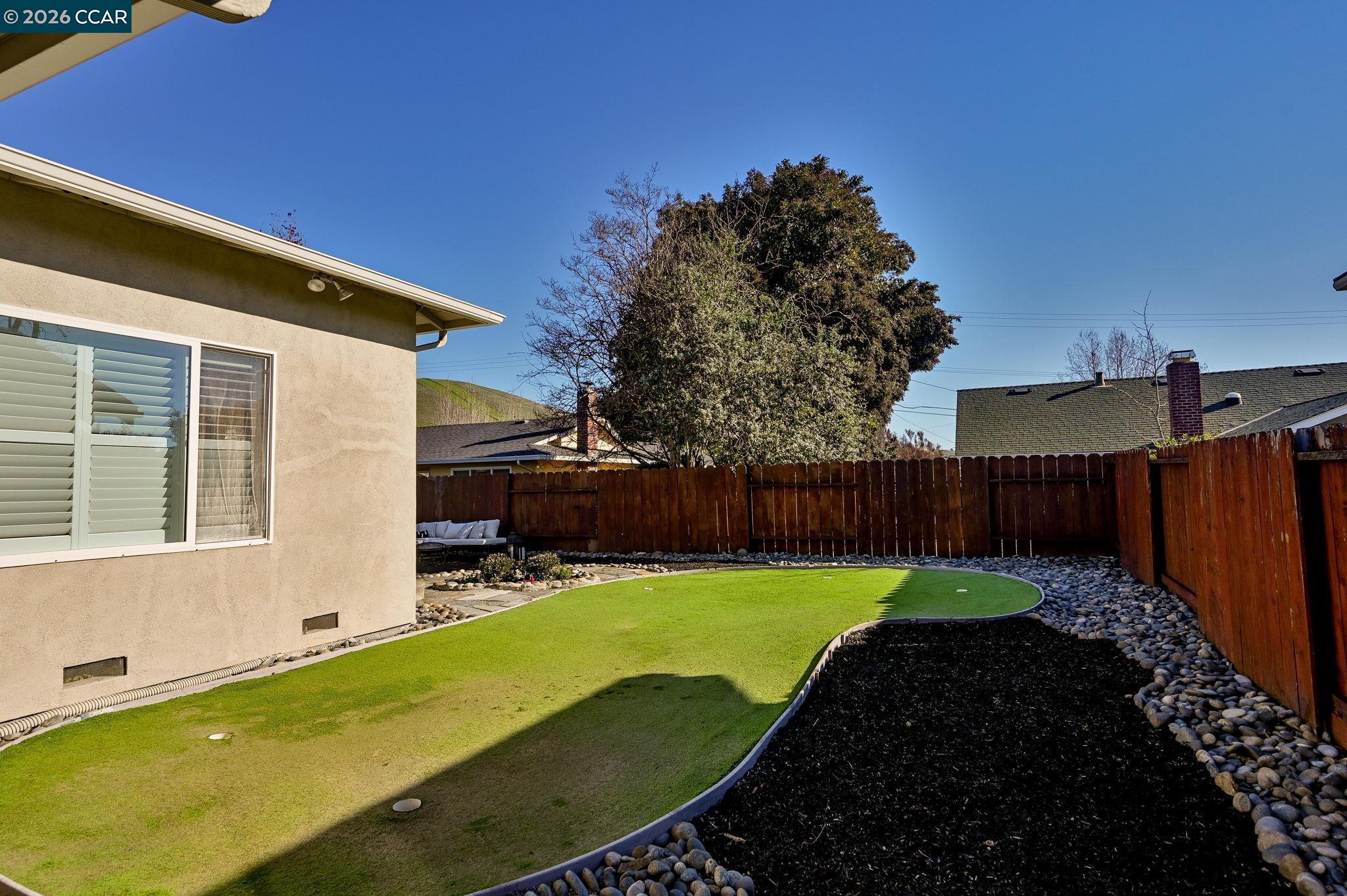 118 Neptune Place San Ramon, CA 94583 - Photo 22 of 36 a view of a backyard with table and chairs with wooden fence