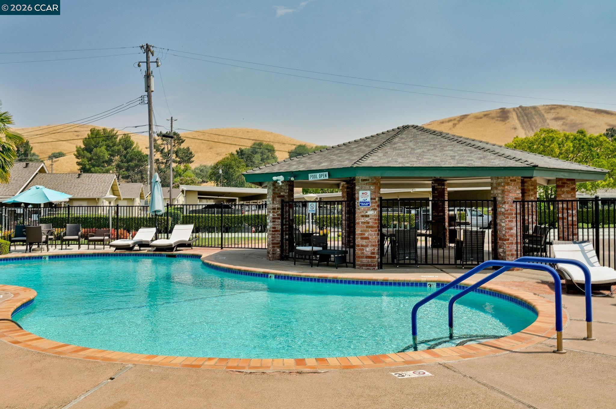 118 Neptune Place San Ramon, CA 94583 - Photo 27 of 36 a view of a house with swimming pool lawn chairs and a yard