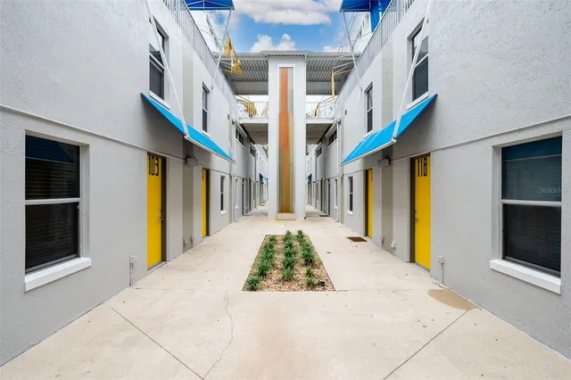 an aerial view of a house with a yard basket ball court and outdoor seating