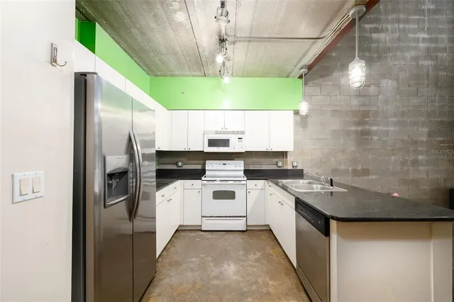 a kitchen with a refrigerator a sink and a stove