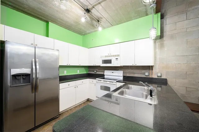 a kitchen with stainless steel appliances granite countertop a sink and cabinets