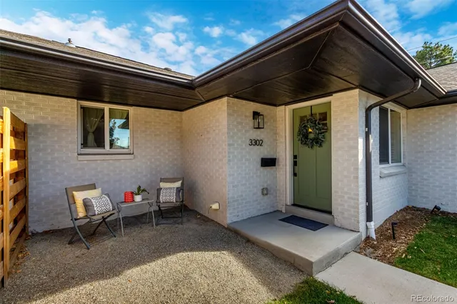 a black and white building with outdoor seating