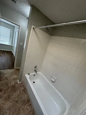 a bathroom with a tub and a sink