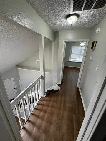 a view of a hallway with staircase