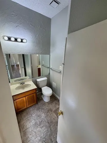a bathroom with a sink a toilet and mirror