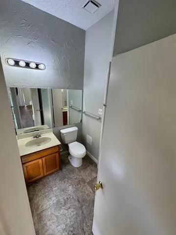 a bathroom with a sink a toilet and mirror