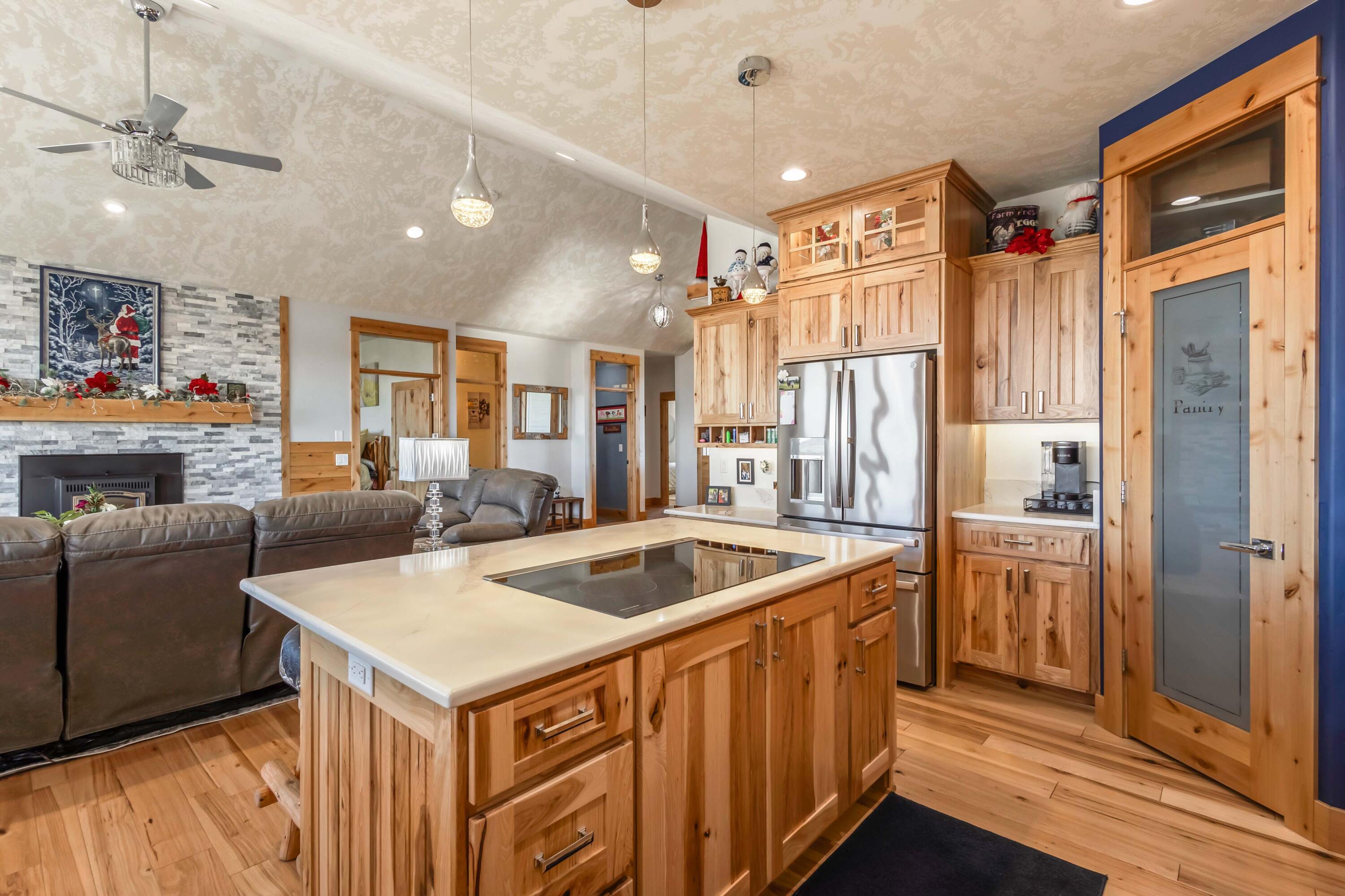 5582 North Mckay Road Prineville, OR 97754 - Photo 11 of 54 a kitchen with a refrigerator a sink and cabinets