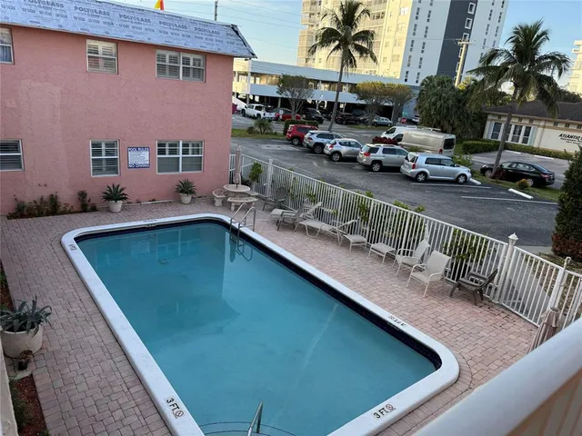 swimming pool view with outdoor seating
