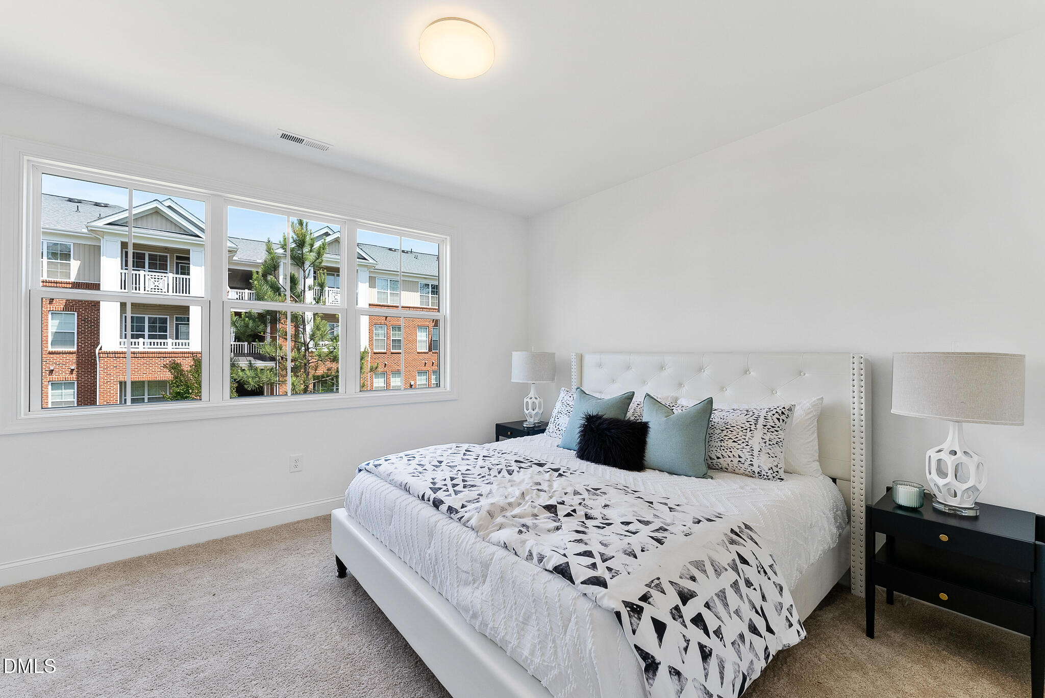 4821 Gossamer Lane, Unit 103 Raleigh, NC 27616 - Photo 13 of 46 a bedroom with a large bed and a large window