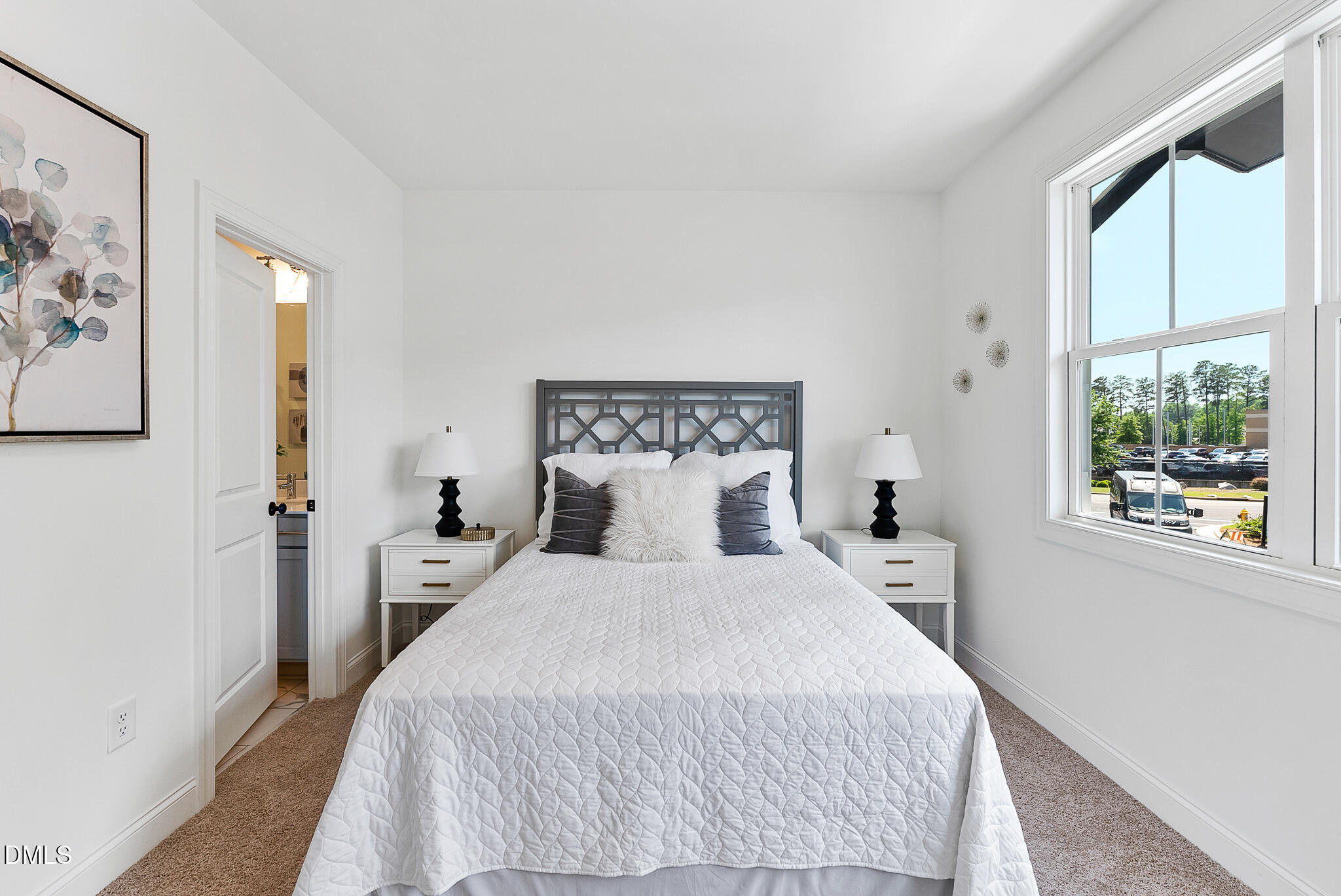 4821 Gossamer Lane, Unit 103 Raleigh, NC 27616 - Photo 17 of 46 a bedroom with a bed and a large window