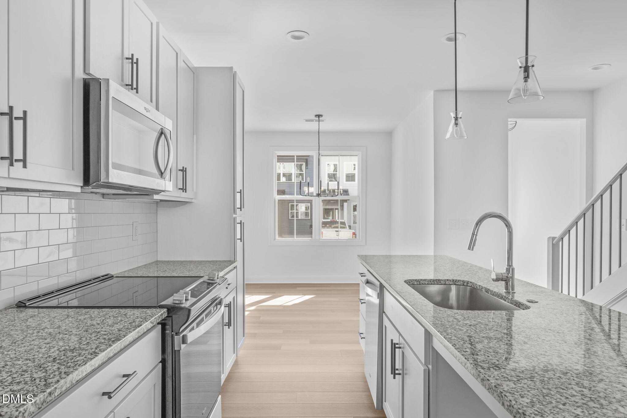 4821 Gossamer Lane, Unit 103 Raleigh, NC 27616 - Photo 5 of 46 a kitchen with granite countertop a sink a stove and kitchen island