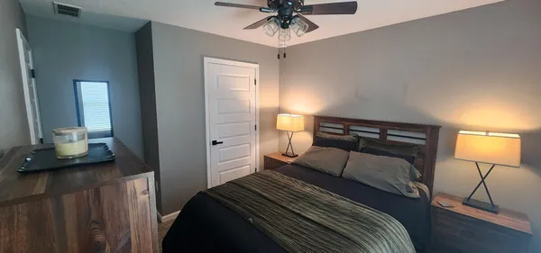 a bedroom with a bed and a chandelier