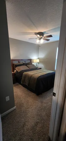 a bedroom with bed and window