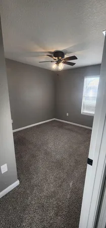 a view of room with stairs and a chandelier fan