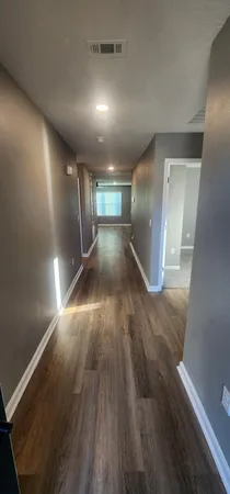 a view of gallery with wooden floor