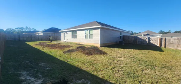 a view of backyard with small cabin