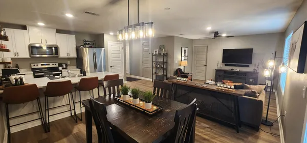 a large kitchen with a table and chairs