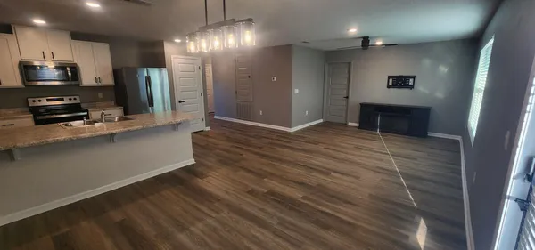 a view of kitchen with sink refrigerator and microwave