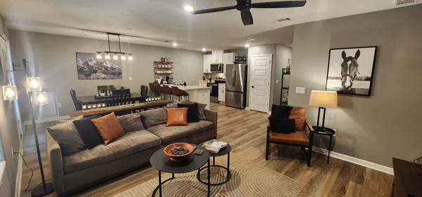 a living room with furniture and a chandelier