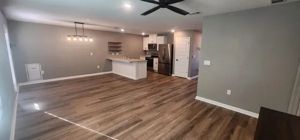 a view of a kitchen with a sink and refrigerator