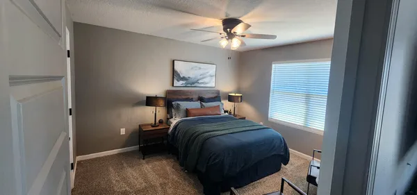 a bedroom with a bed and a chandelier
