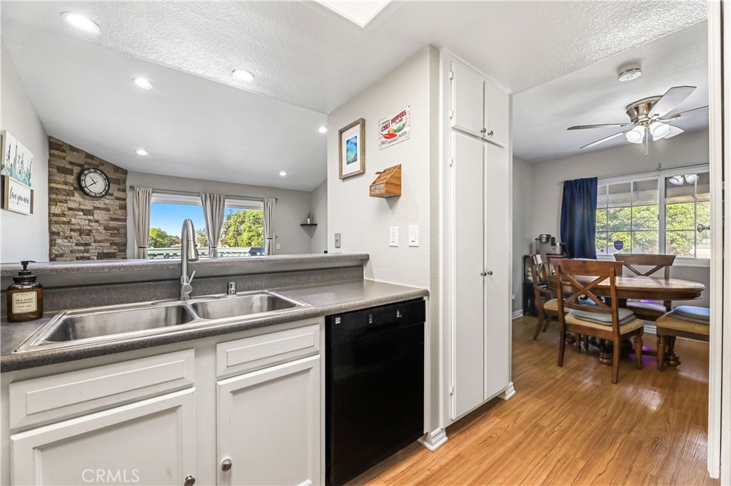 3512 West Stonepine Lane, Unit D Anaheim, CA 92804 - Photo 12 of 38 a kitchen with a sink cabinets and wooden floor
