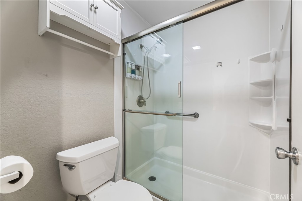 3512 West Stonepine Lane, Unit D Anaheim, CA 92804 - Photo 16 of 38 a bathroom with a toilet and a shower