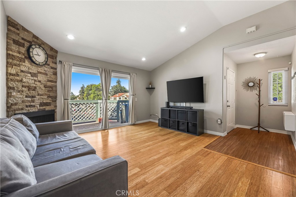 3512 West Stonepine Lane, Unit D Anaheim, CA 92804 - Photo 2 of 38 a living room with furniture and a flat screen tv
