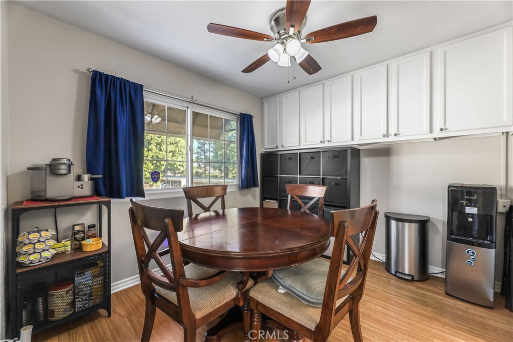 3512 West Stonepine Lane, Unit D Anaheim, CA 92804 - Photo 9 of 38 a view of a dining room with furniture window and wooden floor
