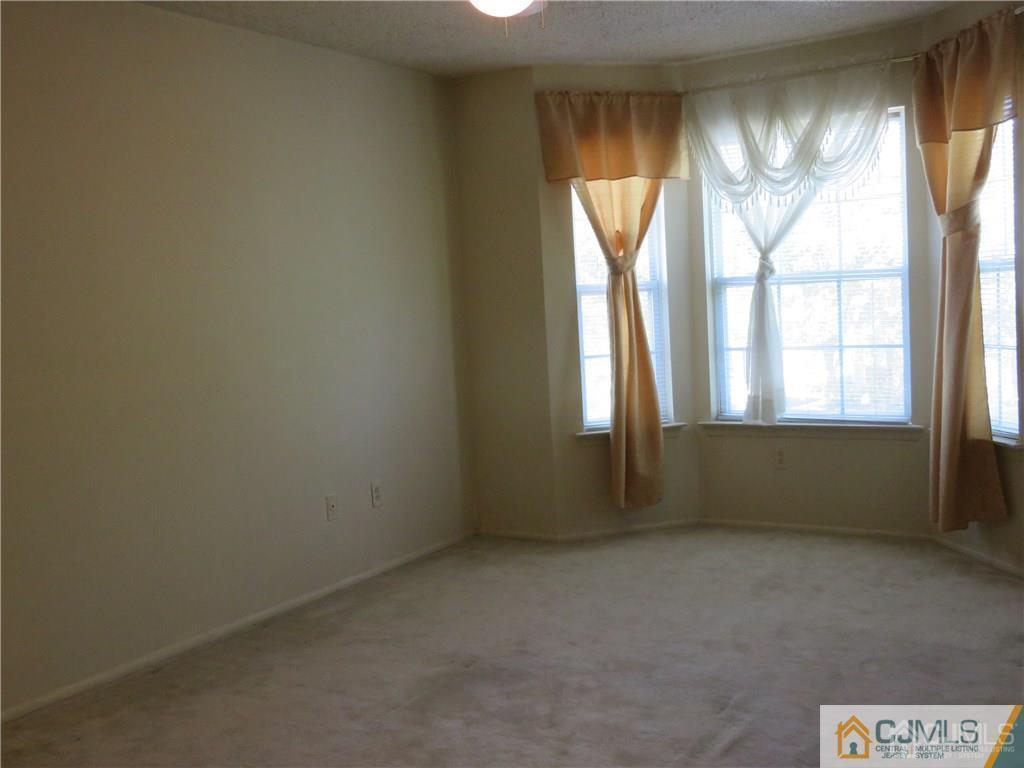 387 Draco Road, Unit 387 Piscataway, NJ 08854 - Photo 11 of 17 an empty room with windows