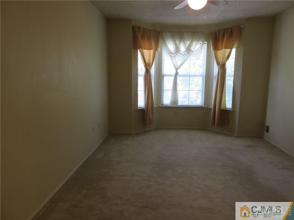387 Draco Road, Unit 387 Piscataway, NJ 08854 - Photo 12 of 17 an empty room with windows