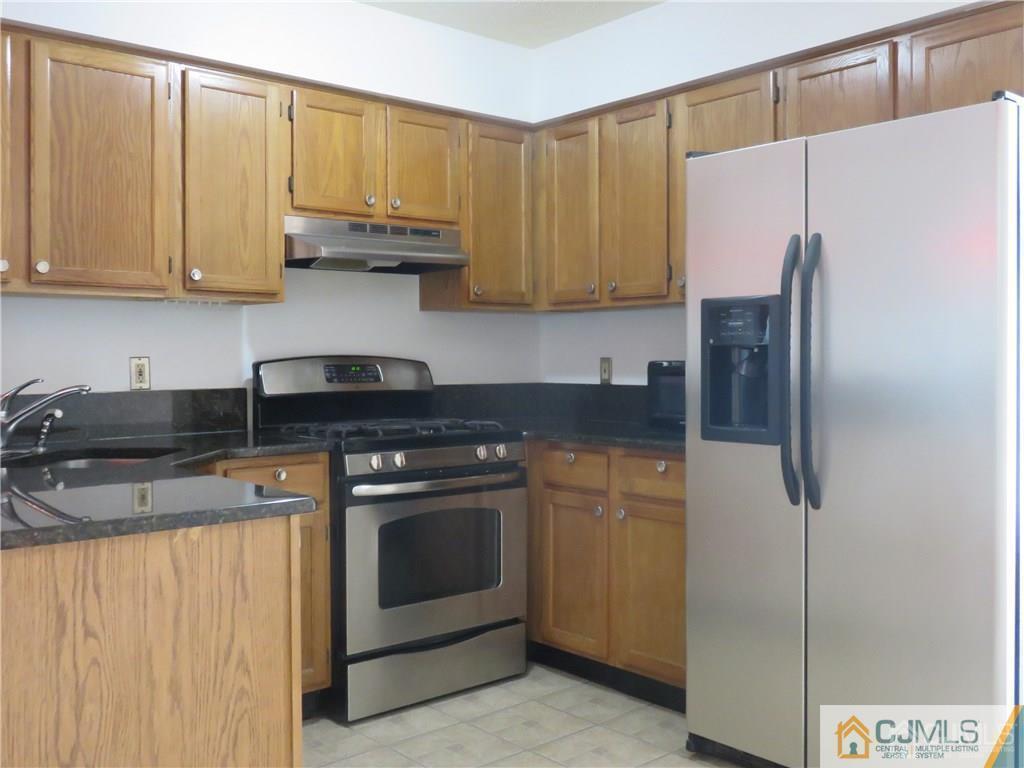 387 Draco Road, Unit 387 Piscataway, NJ 08854 - Photo 3 of 17 a kitchen with stainless steel appliances granite countertop a refrigerator sink and cabinets