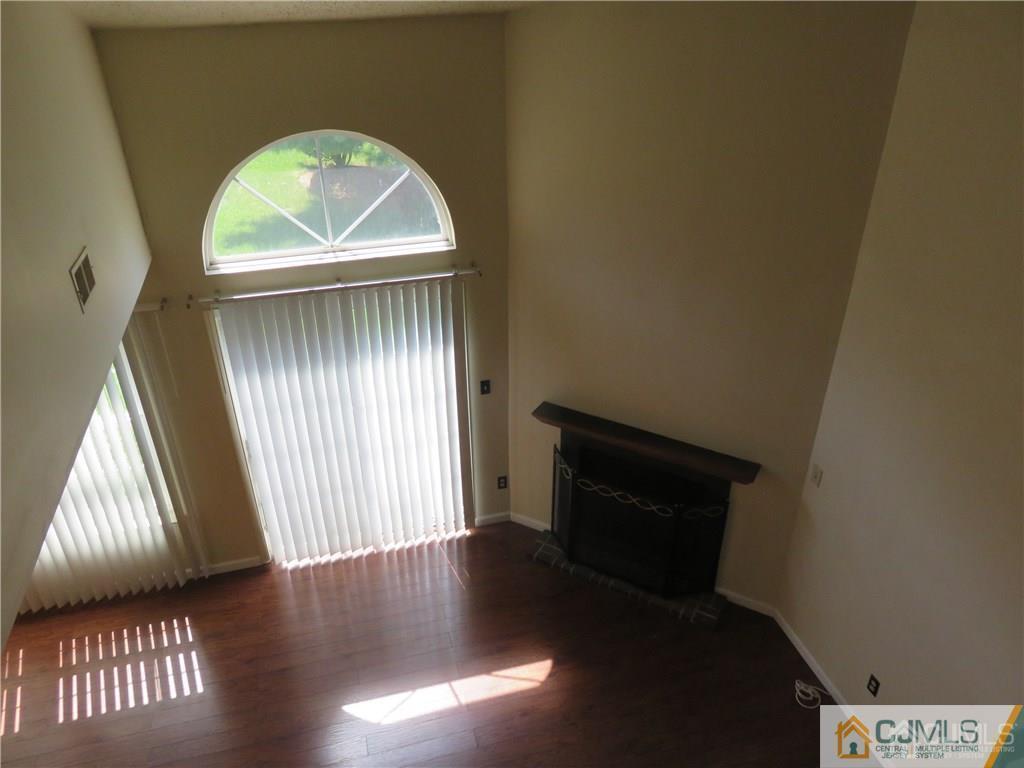 387 Draco Road, Unit 387 Piscataway, NJ 08854 - Photo 9 of 17 a view of wooden floor in a hall with a window
