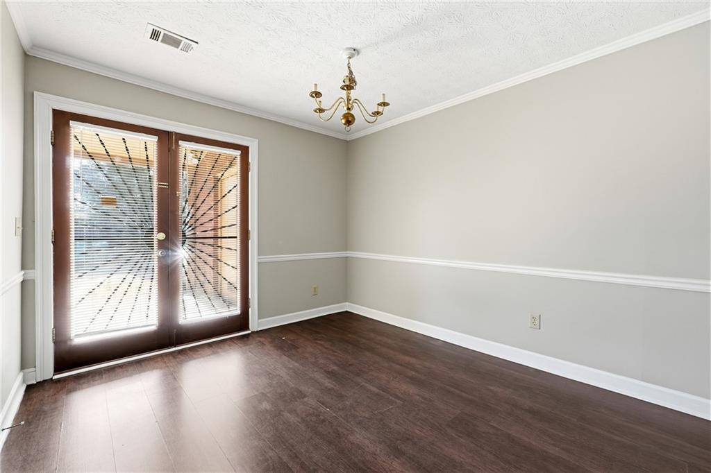 6148 Winfield Court Tucker, GA 30084 - Photo 12 of 27 an empty room with wooden floor and windows