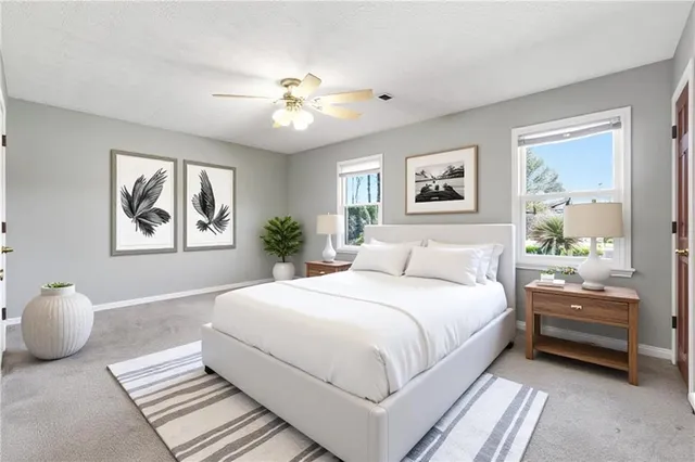 a bedroom with a large bed and a chandelier