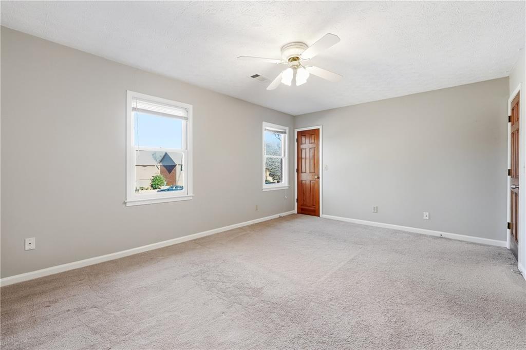 6148 Winfield Court Tucker, GA 30084 - Photo 17 of 27 an empty room with windows and fan