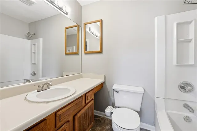 a bathroom with a sink toilet a mirror and vanity