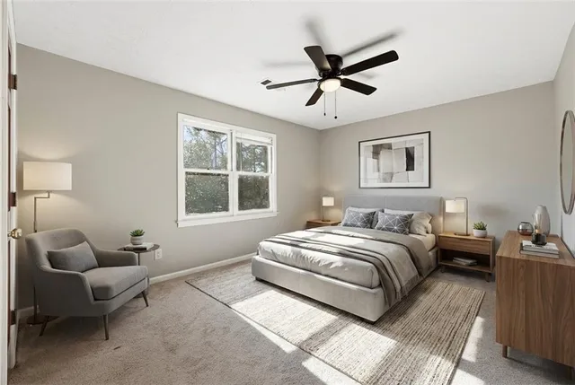 a bedroom with bed couch and window