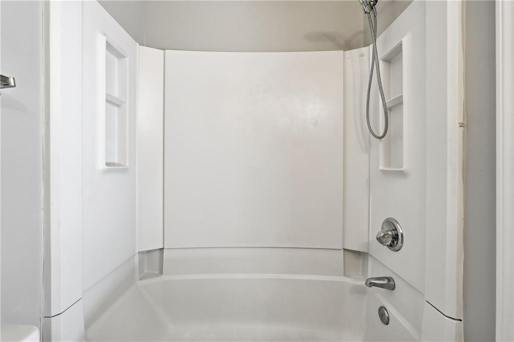 6148 Winfield Court Tucker, GA 30084 - Photo 24 of 27 a bathroom with a bathtub and a shower