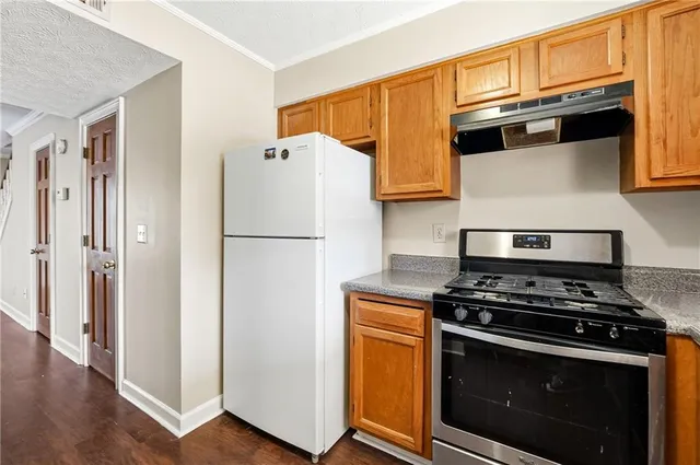 a kitchen with stainless steel appliances a stove a microwave and a refrigerator