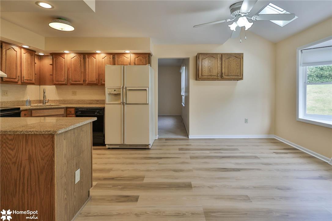 4059 Wedgewood Road Allentown, PA 18104 - Photo 72 of 72 A well-lit kitchen with natural wood cabinetry and a spacious open floorplan for modern living.