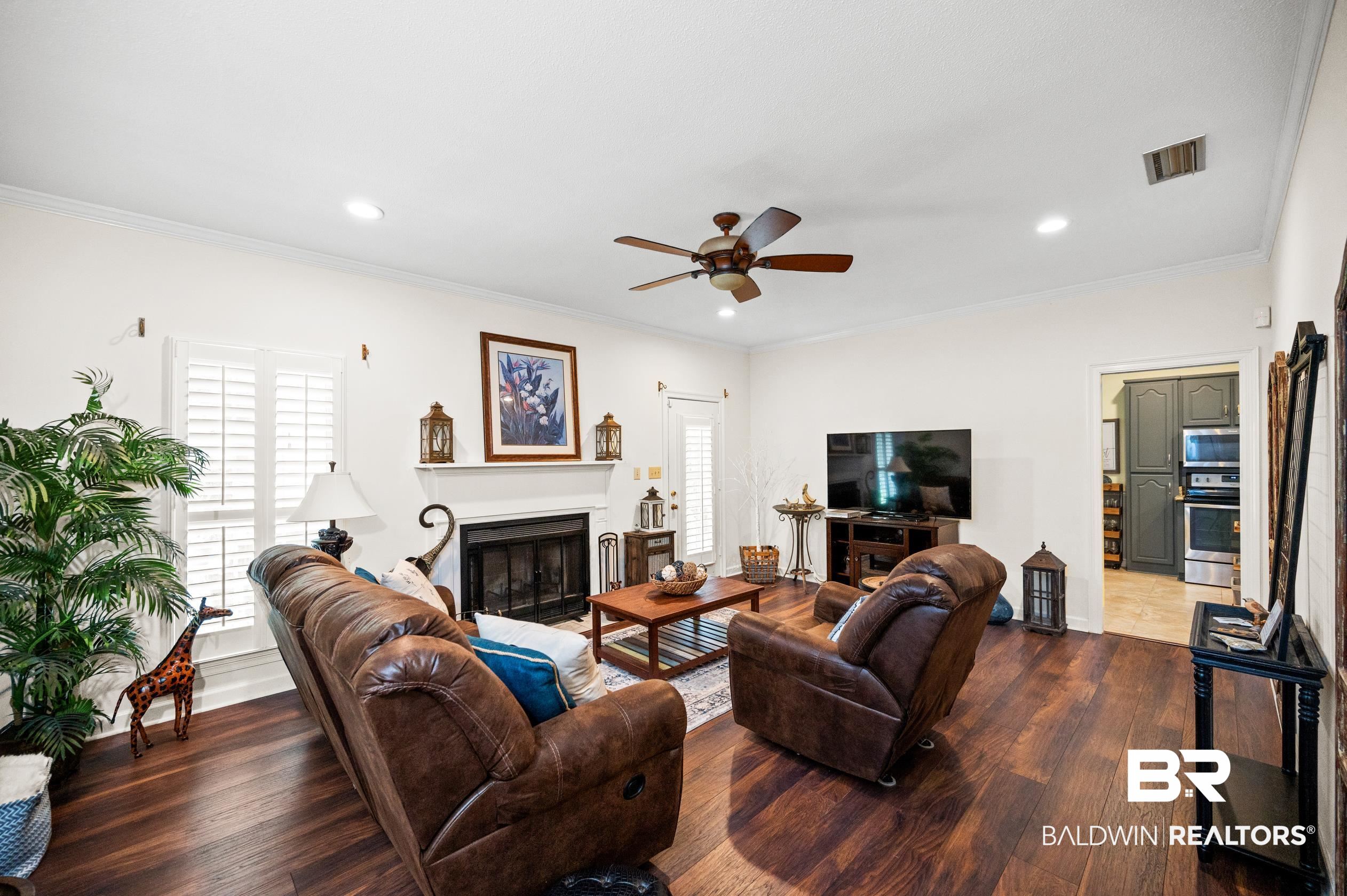 6638 Jackson Square Daphne, AL 36526 - Photo 21 of 62 Living room with wood-type flooring, ceiling fan, and crown molding