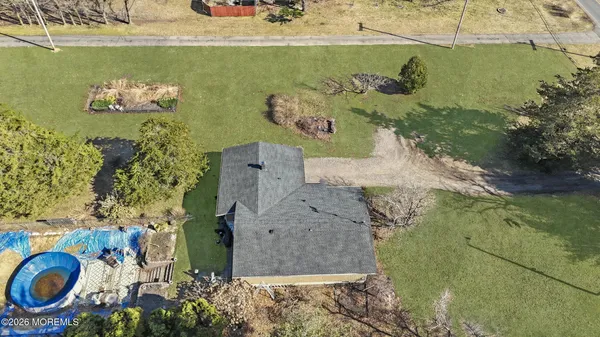 an aerial view of a house with a yard