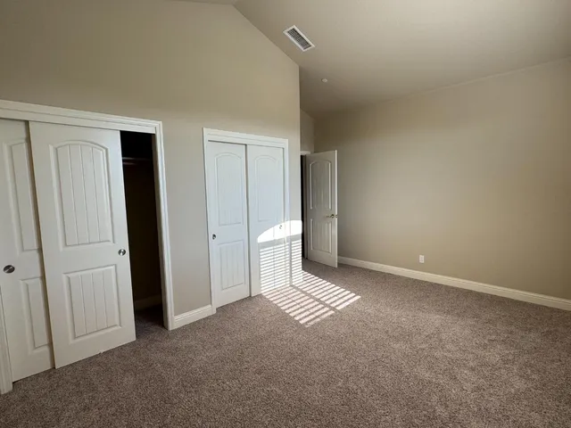 a view of an empty room and closet area
