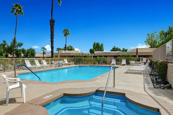 a view of a swimming pool with lounge chairs