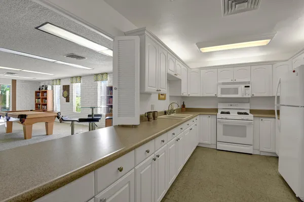 a kitchen with stainless steel appliances granite countertop a sink dishwasher stove and cabinets