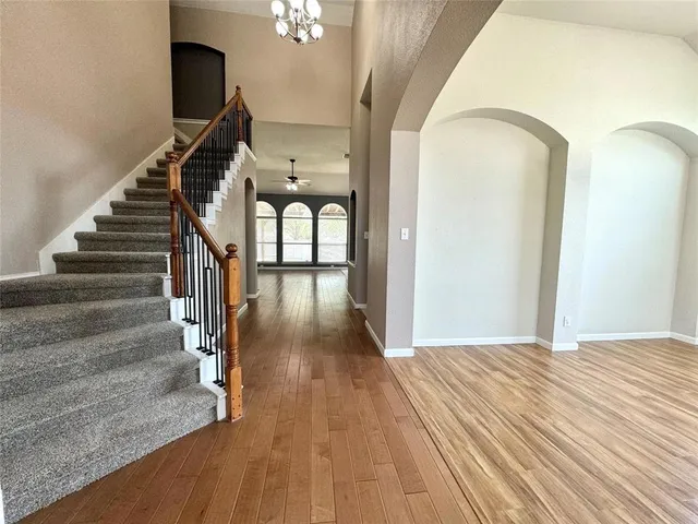 a view of entryway and hall with wooden floor