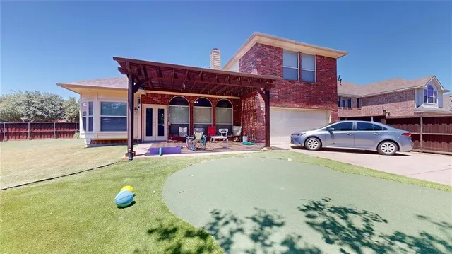 a view of a backyard with sitting area