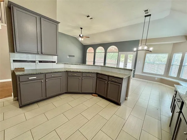 a kitchen with stainless steel appliances granite countertop a sink counter space cabinets and a window