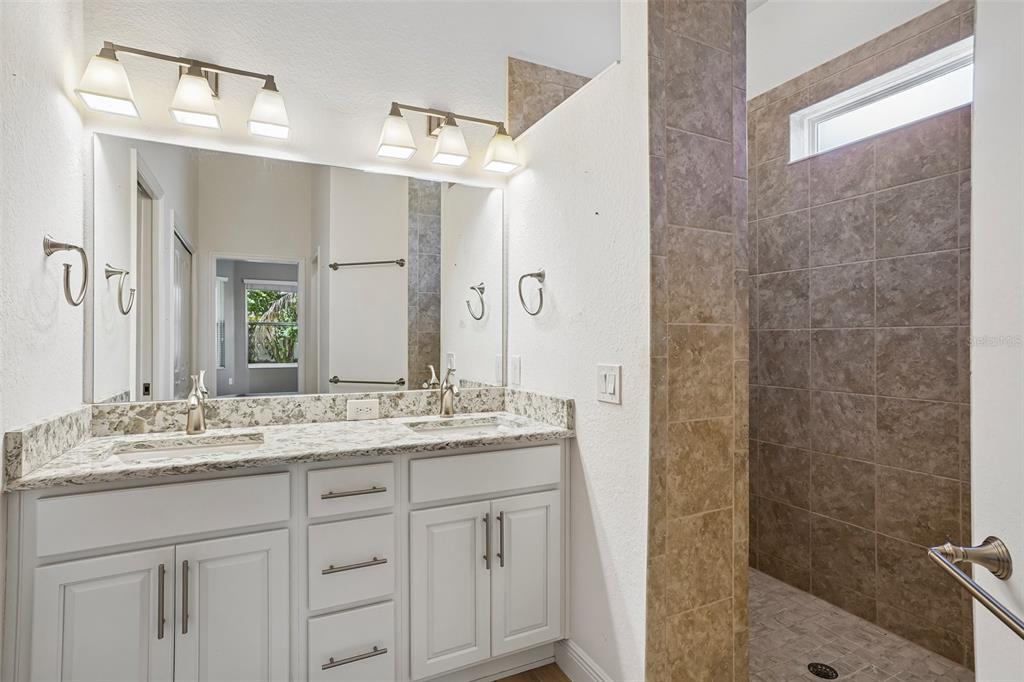 10339 Addison Shore Way Oxford, FL 34484 - Photo 40 of 54 a bathroom with a granite countertop sink mirror and double